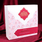 Chocolate packaging with heart patterns and Rocky Mountain Chocolate Factory logo on a red fabric background